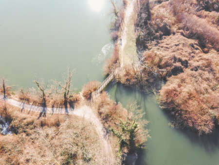 Aerial view of Savica fishing pond, located near eastern heating plant in Zagreb city, above secluded wooden bridge crossing waterの写真素材