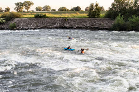 Zagreb, Croatia-May 21st, 2020: Kayakers rowing and having fun in the Sava river rapids at sunset near the Zagreb city, Croatiaのeditorial素材
