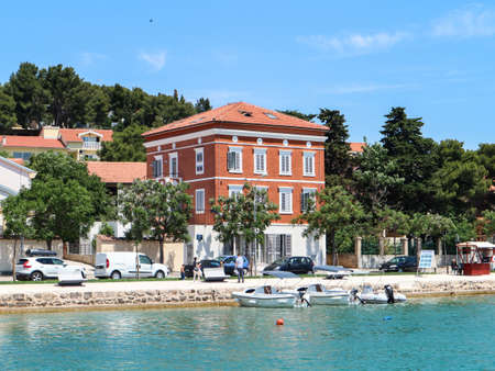 Tisno, Croatia-June 3rd, 2021: Wonderful old house with colorful facade on the shore of Tisno bay, located on the island of Murter, Croatiaのeditorial素材