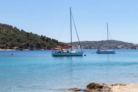 Rogoznica, Croatia-July 06th, 2021: Sailing boats anchored in the wonderful, shallow, turquoise bay of Rogoznica, Croatia, popular tourist and nautical destinationのeditorial素材