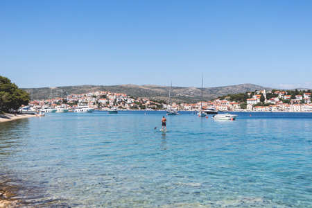 Rogoznica, Croatia-July 06th, 2021: Wonderful Rogoznica bay used as natural port for sailing boats, and calm lagoon for swimming, paddle boarding and other sea activitiesのeditorial素材