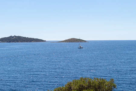 Wonderful view of open sea and islands in archipelago in central Dalmatia from the peninsula of Rogoznica, covered in dense, green pine forestの写真素材