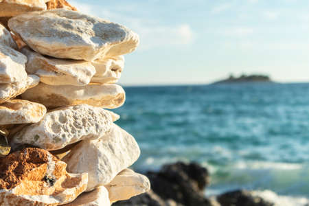 Man made stone formation on the rocky beach of Rogoznica, small fishing place in central Dalmatia, Croatia, at the open sea trashing the shoreの写真素材