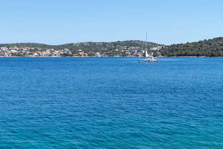 Sailing boat on the path to the Rogoznica Marina located safe, deep in the blue bay of Adriatic seaの写真素材