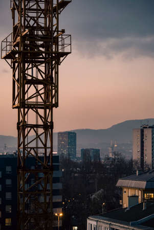 Zagreb, Croatia-December 17th, 2021: Zagreb panorama photographed during sunset, with building crane in the foreground and city landmarks in the backgroundのeditorial素材