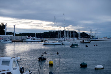 Rovinj, Croatia-January 6th, 2022: Anchored sailing boats in the Rovinj city port, during winter sunsetのeditorial素材