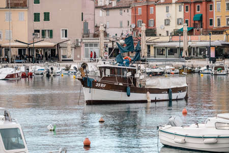 Rovinj, Croatia-January 6th, 2022: Anchored sailing boats in the Rovinj city port, during winter sunsetのeditorial素材