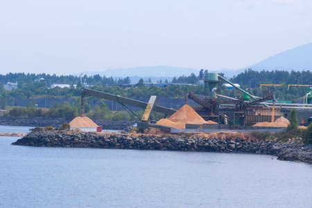 Piles of wood chips at pulp millの写真素材