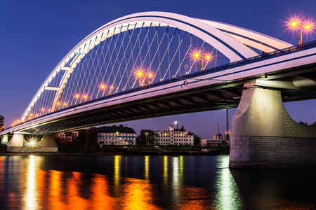 Illuminated Apollo bridge with lights reflection on surface of Danube river at dusk in Bratislava, Slovakia. Travel and engineering  theme.のeditorial素材