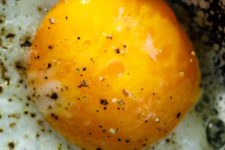 Detail of egg on pan covered with spices.
