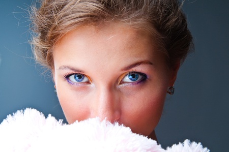 Large studio portrait of the girl with a soft toy against a dark backgroundの写真素材