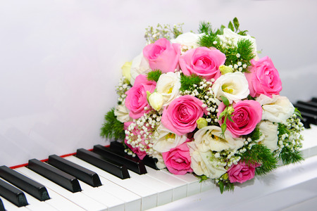 Beautiful  wedding  bouquet from roses lies on piano keysの写真素材