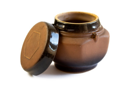 Old rough earthenware jug, close up, isolated on white backgroundの写真素材