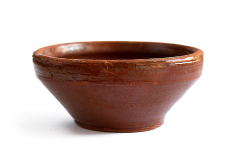 Old rough earthenware bowl close up isolated on white backgroundの写真素材