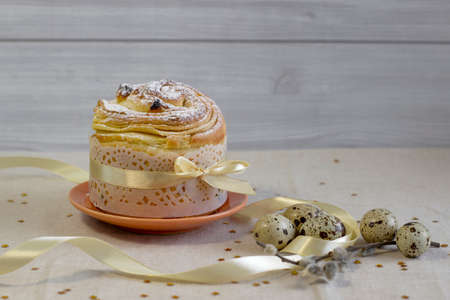 Easter Cake - Russian and Ukrainian Traditional Kulich with easter eggs on a light wood background Bread Selective focusの写真素材