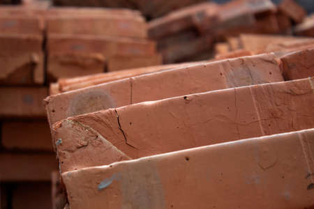 Pile of old dark red bricks, macro photo, close up front view