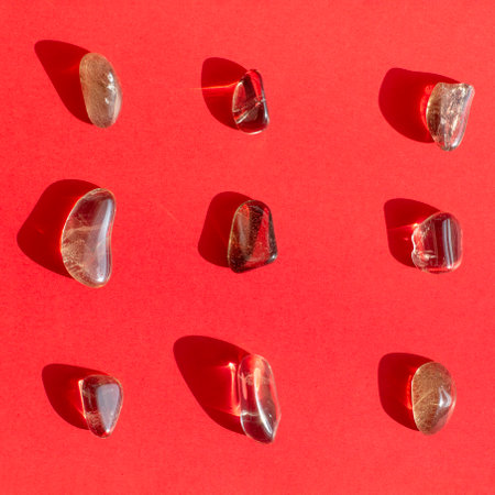 Citrine yellow gem geode crystals geological mineral on red background close upの写真素材