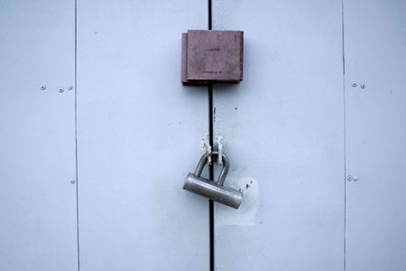 Iron lock on gray painted iron door, security gate shutter close upの写真素材