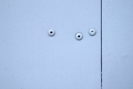 Metal old weathered gray rivets door part close-up industrial background design base front view