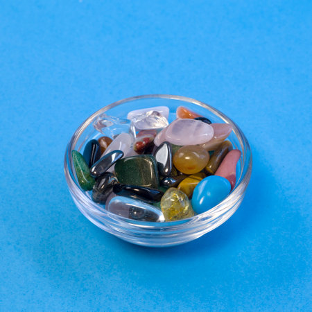 Collection Of Semi-Precious Gemstones on bright blue board background close upの写真素材