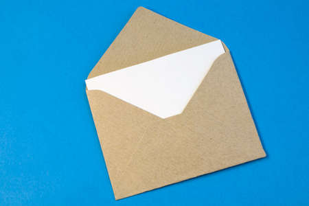 Simple small envelope with space for writing on bright red background close-up Narrow focus line,...
