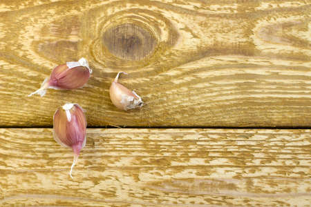Dried garlic on glass plate close up flat lay photo on gray textured wooden background top viewの写真素材