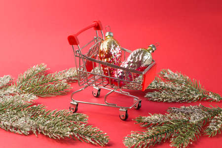 shoping cart with fir branches basket supermarket Winter holiday sales, seasonal sales, Black Fridayの写真素材