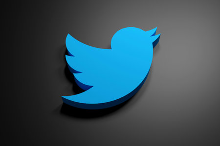 3d rendered blue twitter logo on a shiny black backgroundのeditorial素材