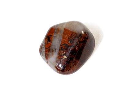 Red and multicolored jasper polished tumblestones as nice natural background on white plateの写真素材