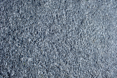 Gray small rocks ground texture. black small road stone backgroundの写真素材