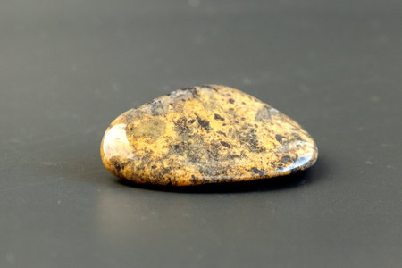 Red and multicolored jasper polished tumblestones as nice natural background on white plateの写真素材