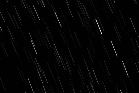 The movement of the stars leaves bright lines in the night black skyの写真素材