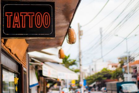 The lightbox on the city street with the name of the Tattoo serviceの写真素材