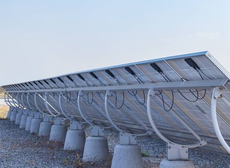 The back side of the solar panels, which is mounted on concrete supports. Sunny day