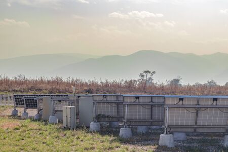 The back side of the solar panels, which is mounted on concrete supports. Sunny dayの写真素材