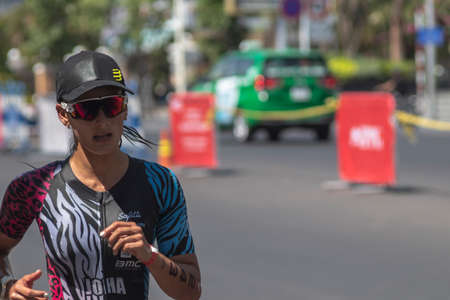 NHA TRANG, KHANH HOA PROVINCE, VIETNAM - JULY 14, 2019 Johanna Solano is a triathlon participant in the Challenge Vietnam event, she runs a 21 kilometer stretch along Tran phu Street near the seaのeditorial素材