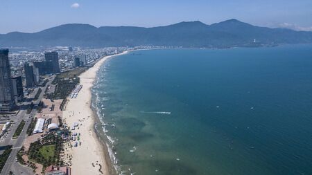 View of the first coastline of Da Nang in Vietnam against the backdrop of the mountains. Photo from a droneの写真素材