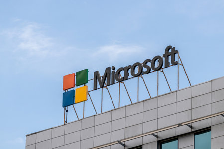 Almaty, Kazakhstan - July 6, 2021: Microsoft name and logo installed on the roof of a city office building. Against the background of the blue sky and clouds.のeditorial素材