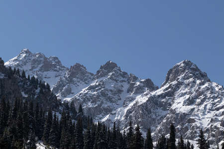View of large mountain rocks in the snow. Against the blue skyの写真素材