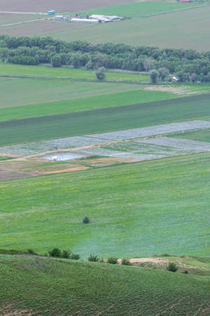 Farming fields with irrigation pool. View from the height of the mountainsの写真素材