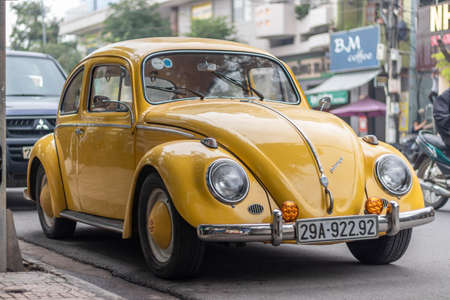Nha Trang, Khanh Hoa Province, Vietnam - January 9, 2019: An old yellow Volkswagen beetle stands in a parking space near the sidewalk. Excellent conditionのeditorial素材