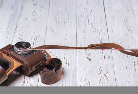 An old retro camera in a brown leather case with film. vintage photoの写真素材