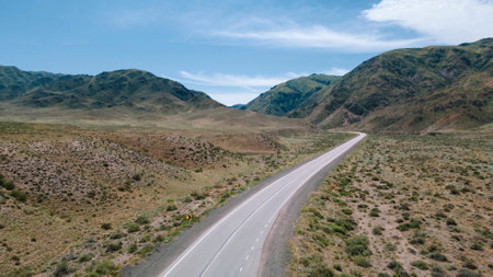 Asphalt road leading into the gorge of the mountains. deserted terrainの写真素材