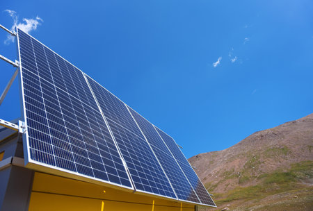 Solar panels are installed on the facade of the house. mountain landscape. Sunny dayの写真素材