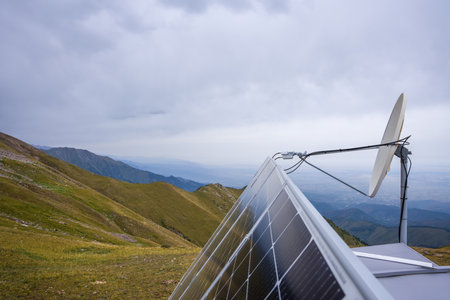 Roof with solar panels and antenna in the mountains. Green energy