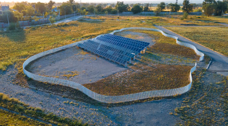 Rows of solar panels on the territory of the station with a fence. Green energy