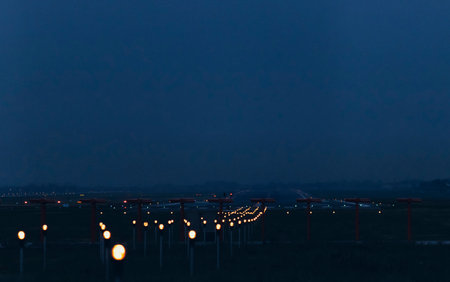 Blurred lines of runway lights at an airport. Evening time