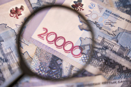 Part of a blurred 20,000 tenge banknote through a magnifying glass. Paper cash