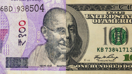 Half of a 100 rupee and 100 dollar noteの写真素材