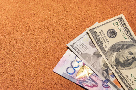 Old and new 100 dollar bill and tenge banknote